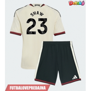 Lacne Dětský Futbalové dres Manchester United Luke Shaw #23 2026-27 Krátky Rukáv - Tretina (+ trenírky)